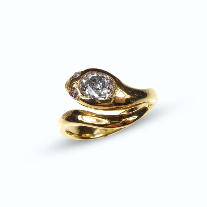 Cushion cut diamond and gold snake crossover ring